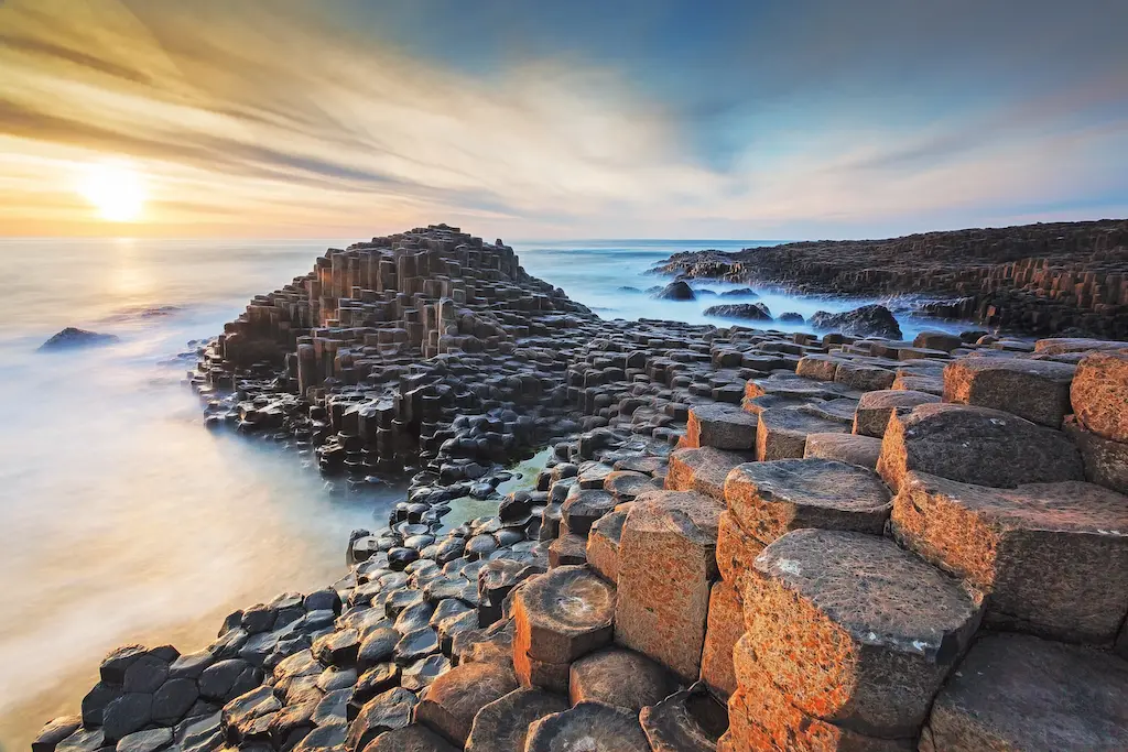 The Giants Causeway in Belfast. Rocks by the sea with a sunset